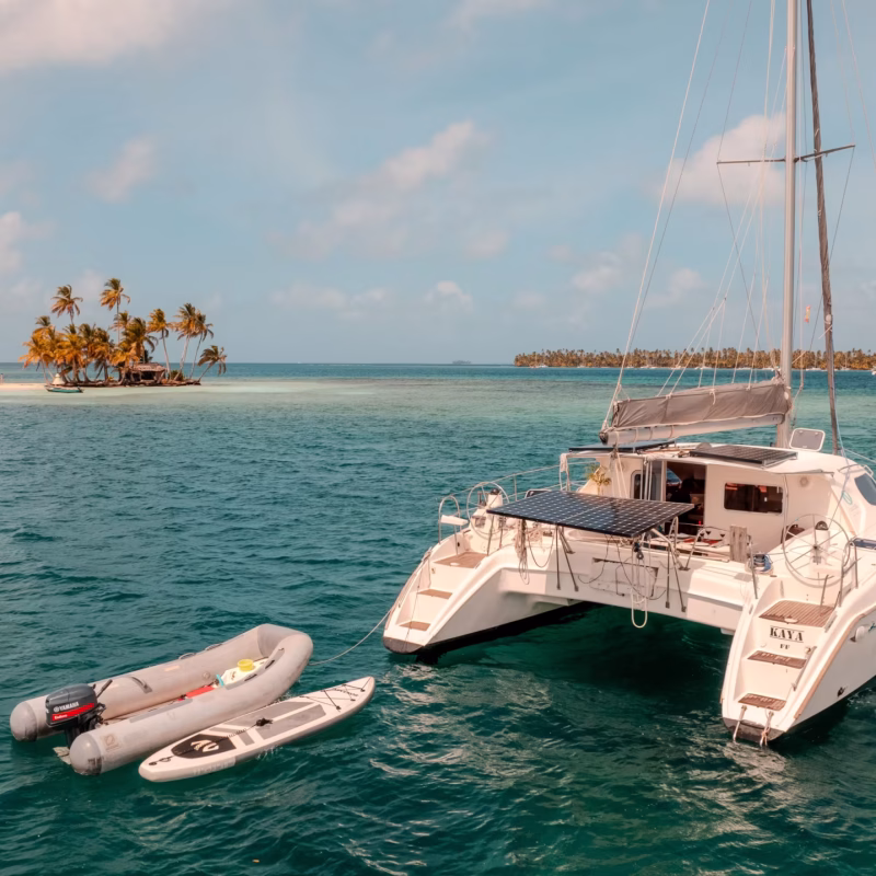 Nautitech 395K catamaran anchored with paddleboards near a coral islet in San Blas