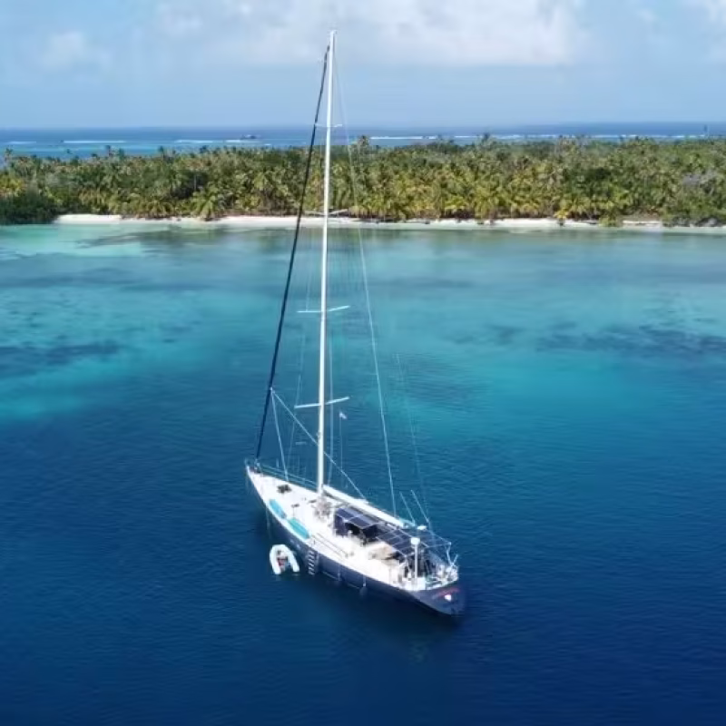 Frers 73 luxury sail yacht anchored near coral reefs in the San Blas Islands