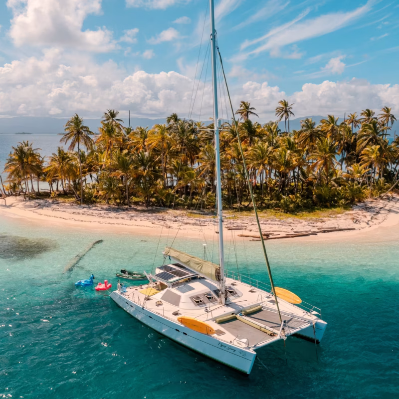 Lagoon 55F catamaran anchored near a palm-covered island in the San Blas archipelago